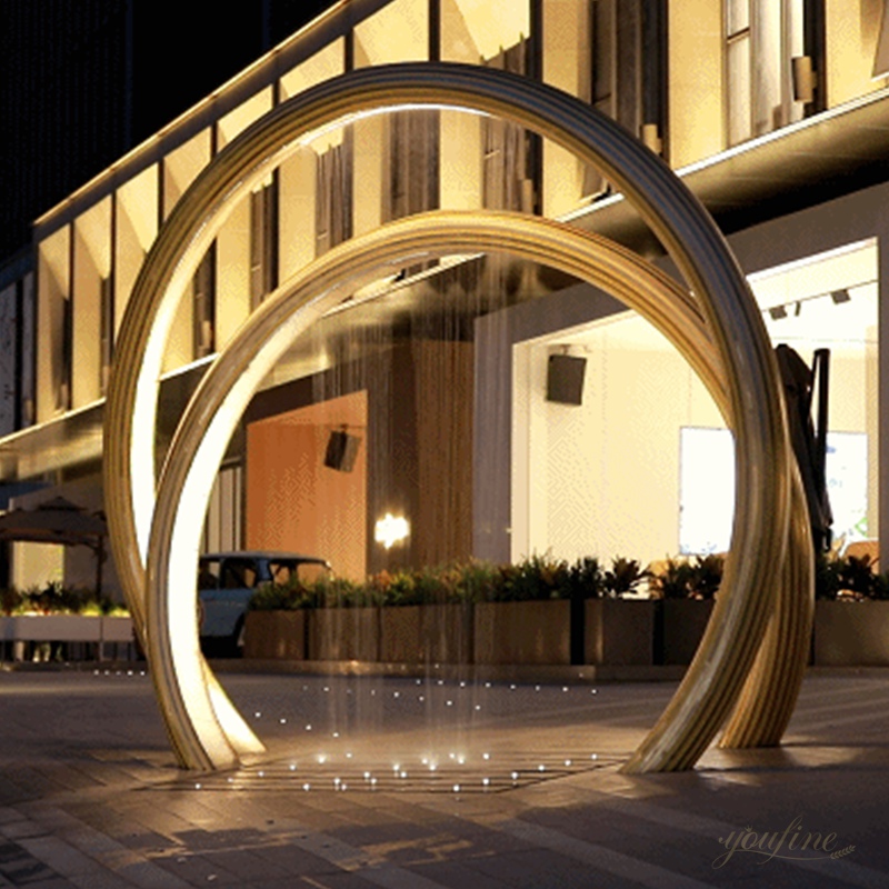 Abstract ring metal sculpture fountain with lights