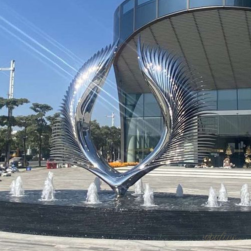 Hand-forged stainless steel mirror-polished wing sculptures on the plaza outside the building