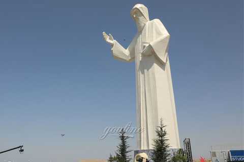 large white marble st charbel statue outside garden