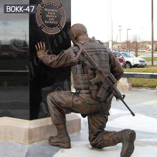 soldier kneeling at cross statue