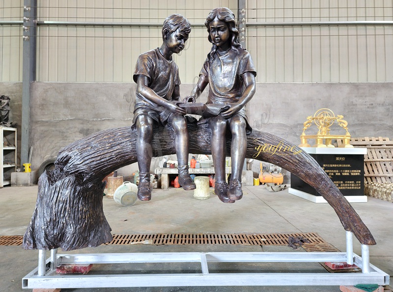 Boy and Girl Reading on Tree Branch