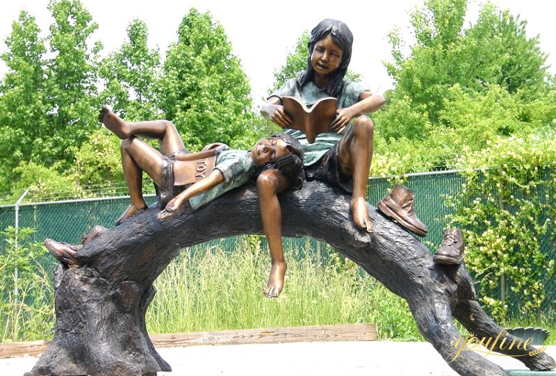 girl reading book garden statue