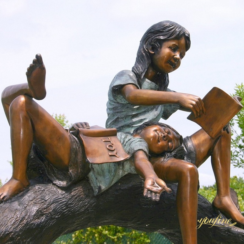 girl reading book statue