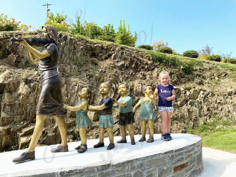 bronze teacher and child sculpture