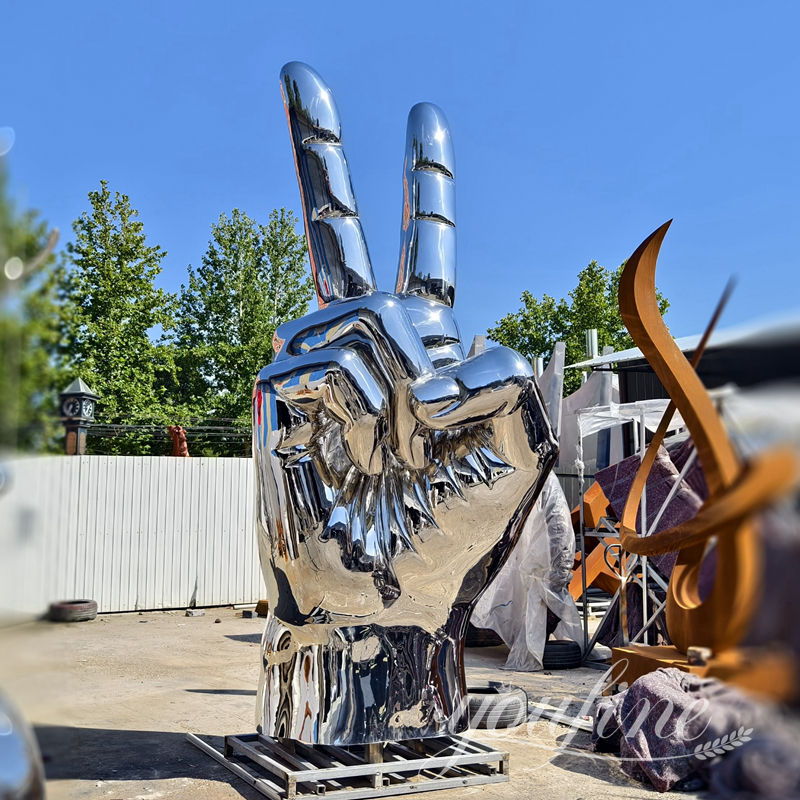 large stainless steel hand sculpture