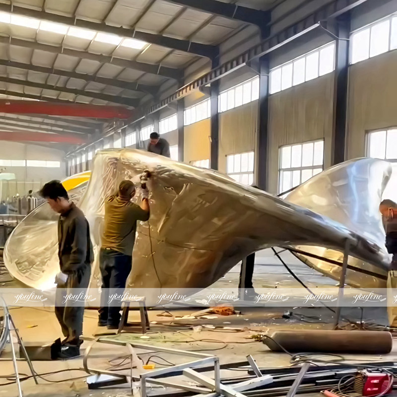 YouFine team forging and polishing the large stainless steel Mobius strip sculpture