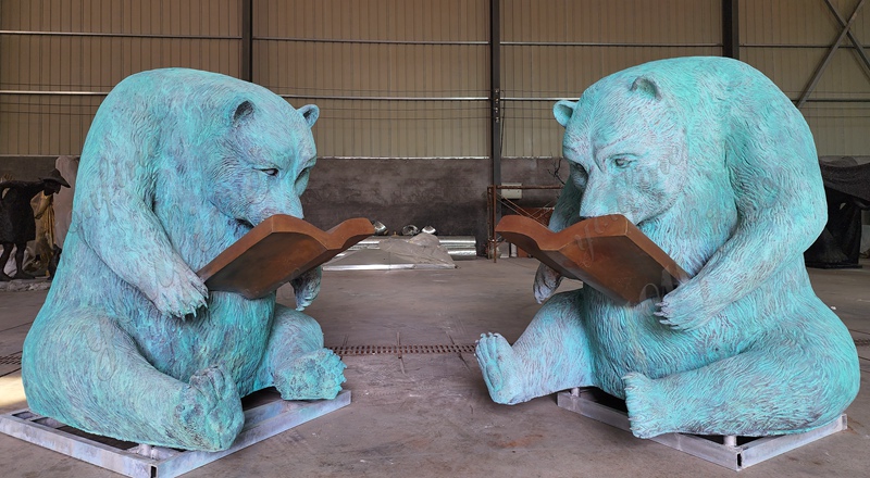 Bear sculpture reading quietly